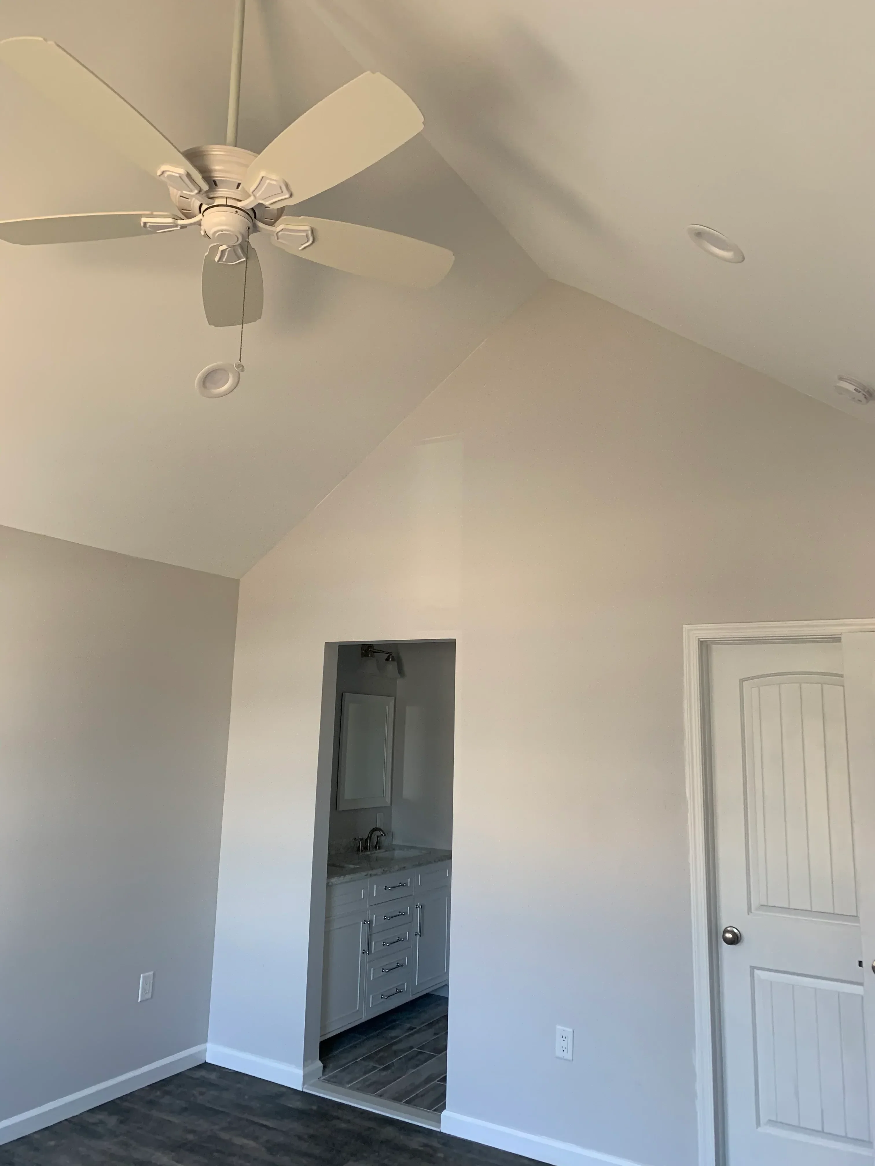 Ceiling with installed fan, HVAC return vent, recessed lighting, and finished drywall