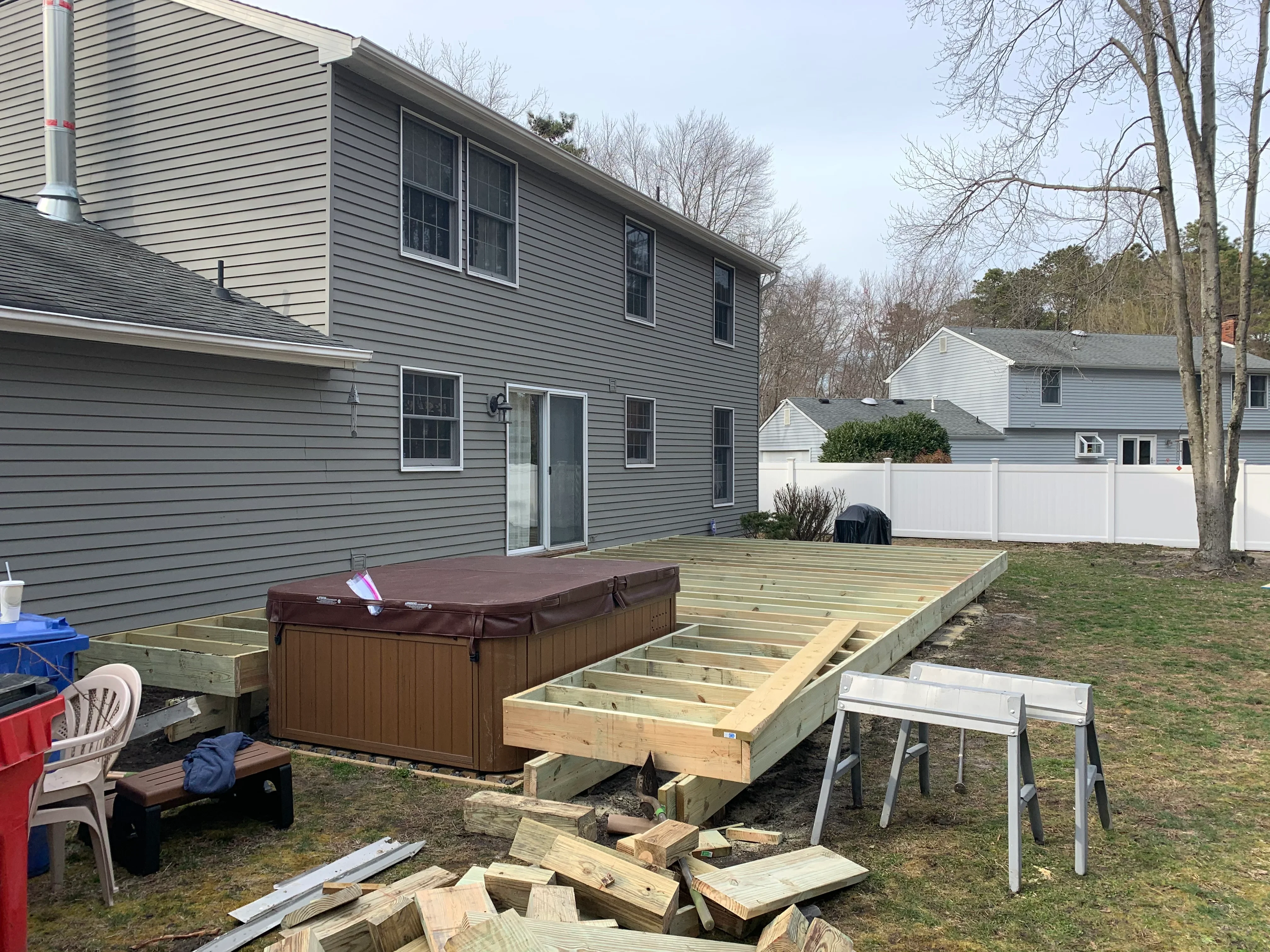 Pressure-treated deck framing with joists and beams during construction phase