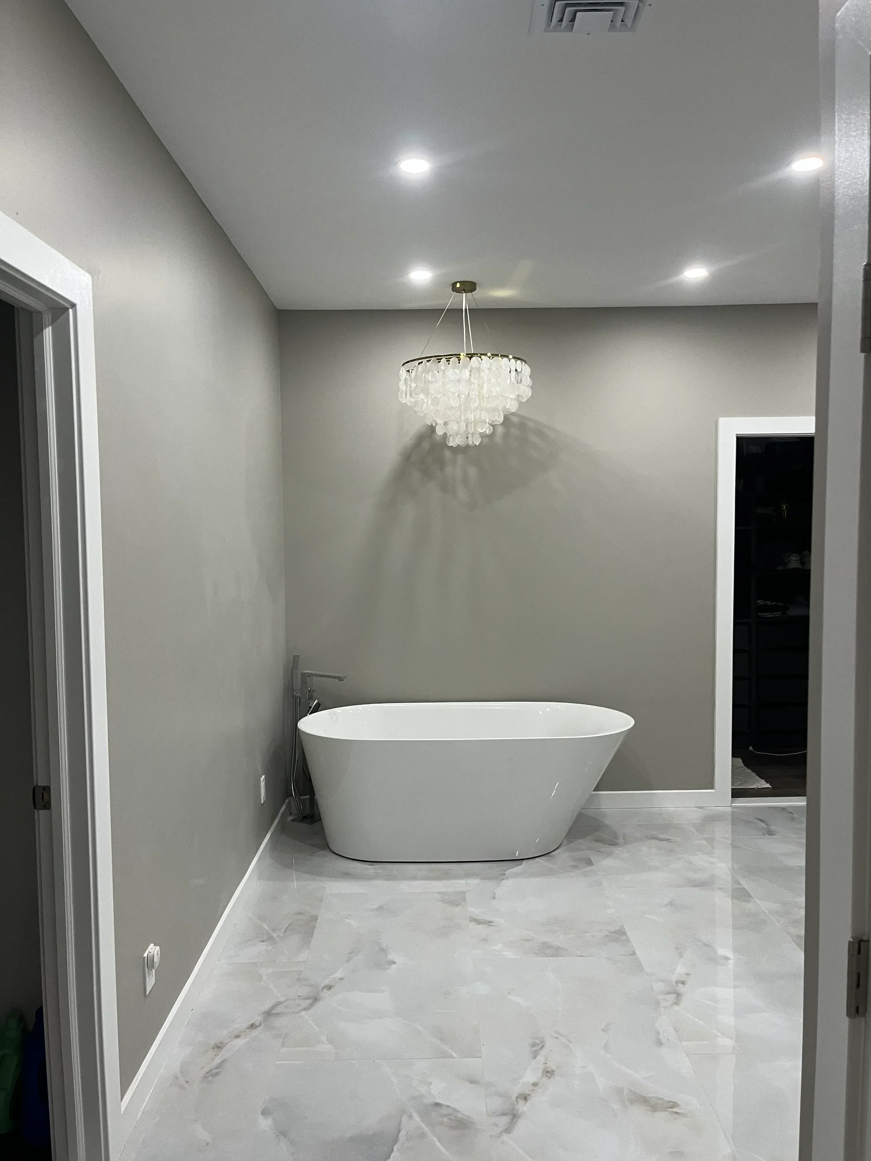 Bathroom with marble tile wall, concrete floor, recessed lighting, and white vanity cabinet