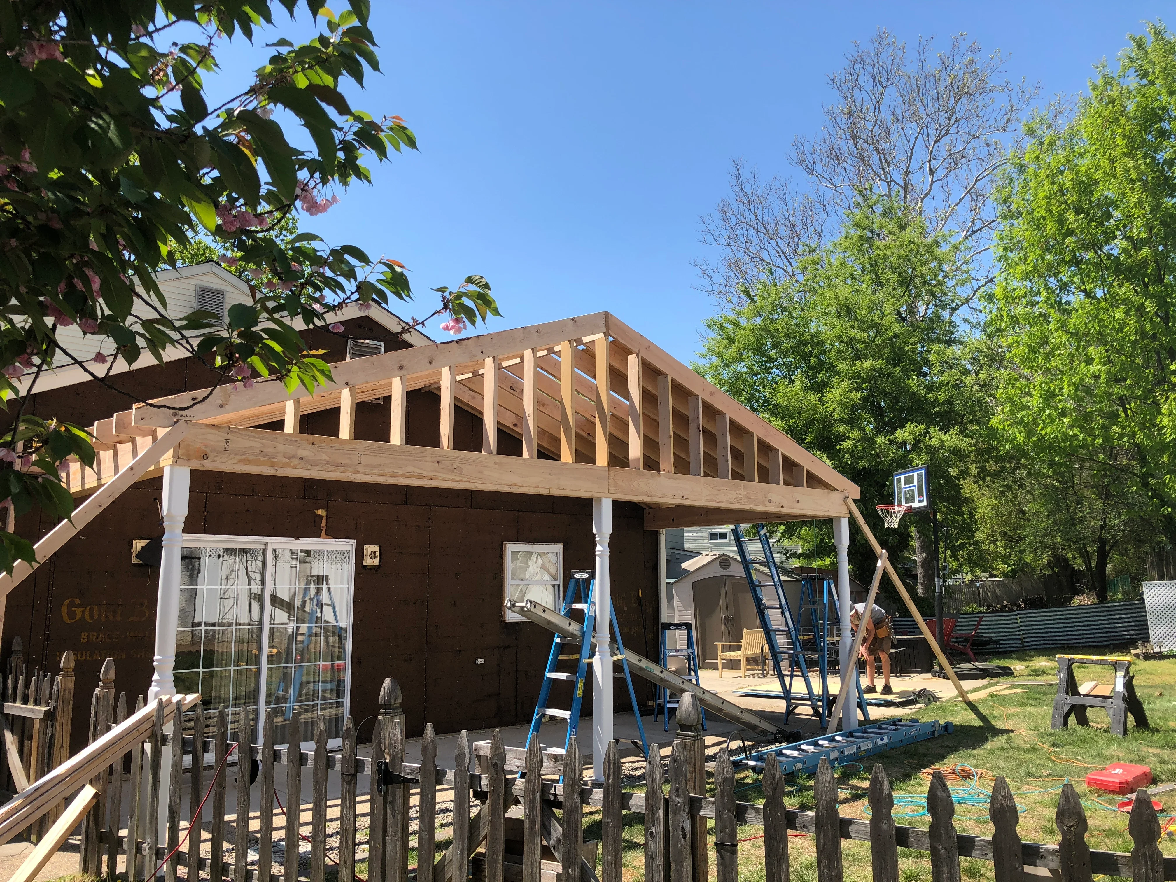 Timber roof framing with exposed trusses on residential addition under construction