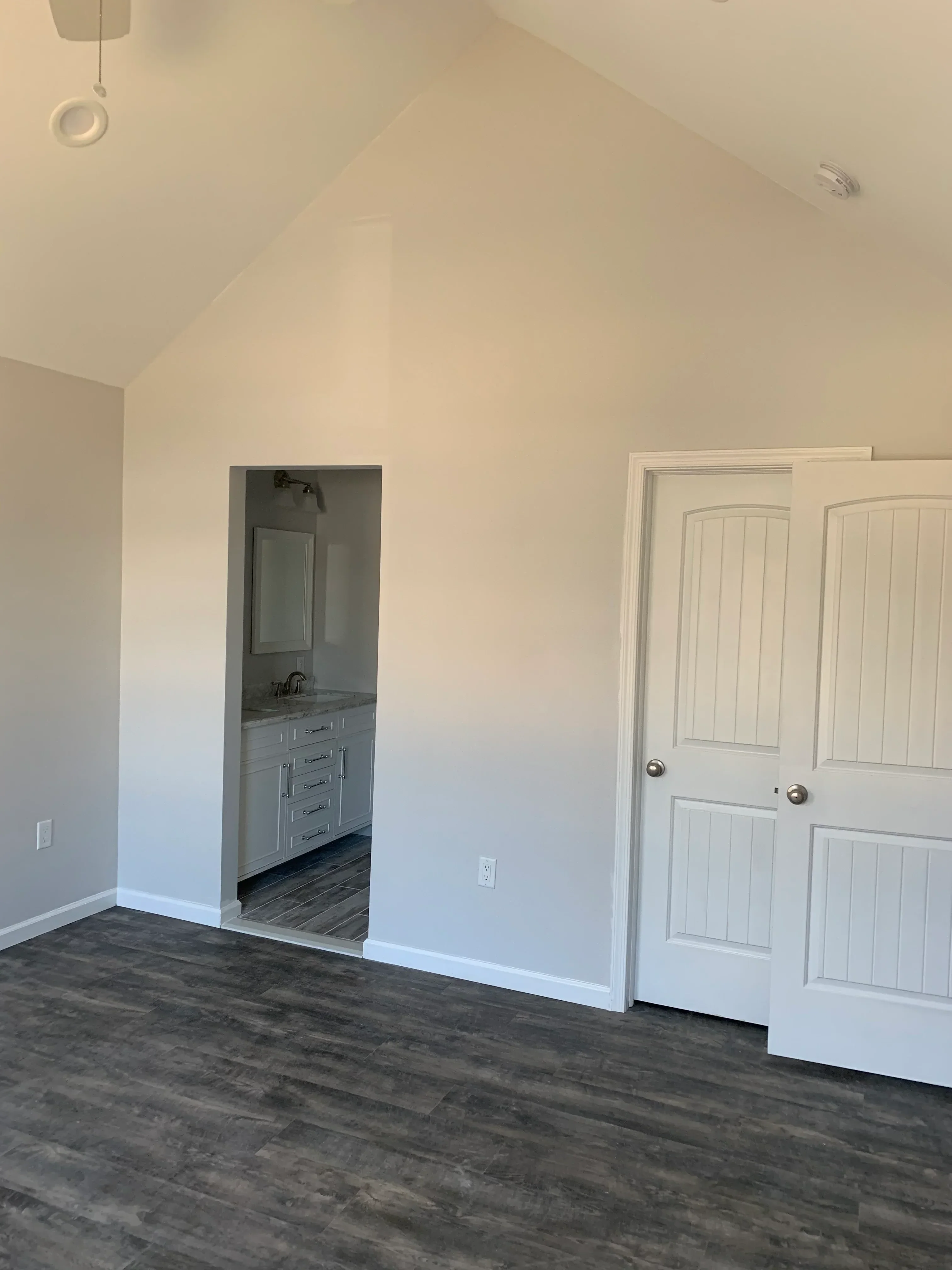 Finished laundry room with white drywall, recessed lighting, louvered closet door, and utility appliance space