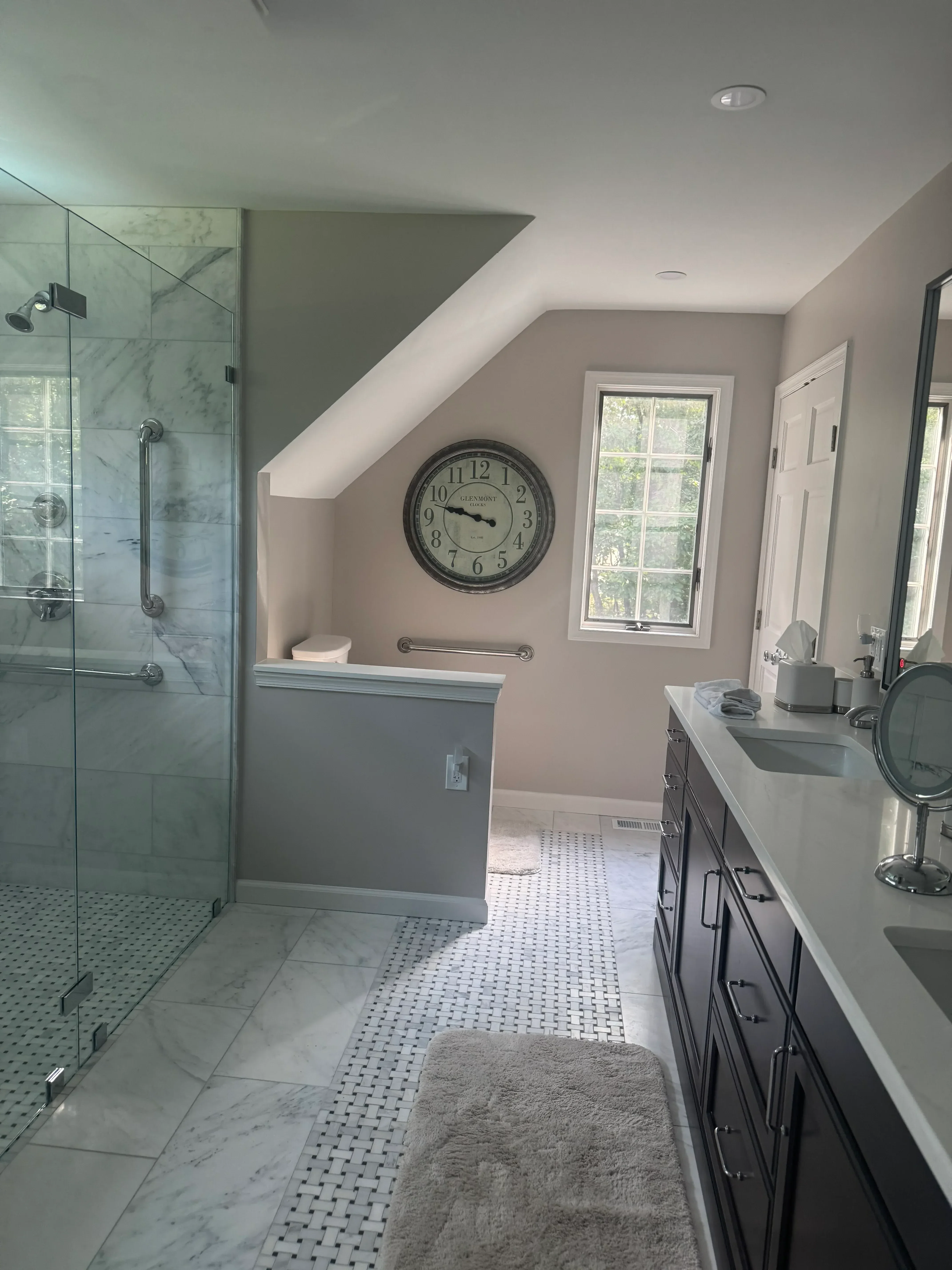 Marble tile bathroom with glass shower enclosure, subway tile walls, and recessed ceiling lights