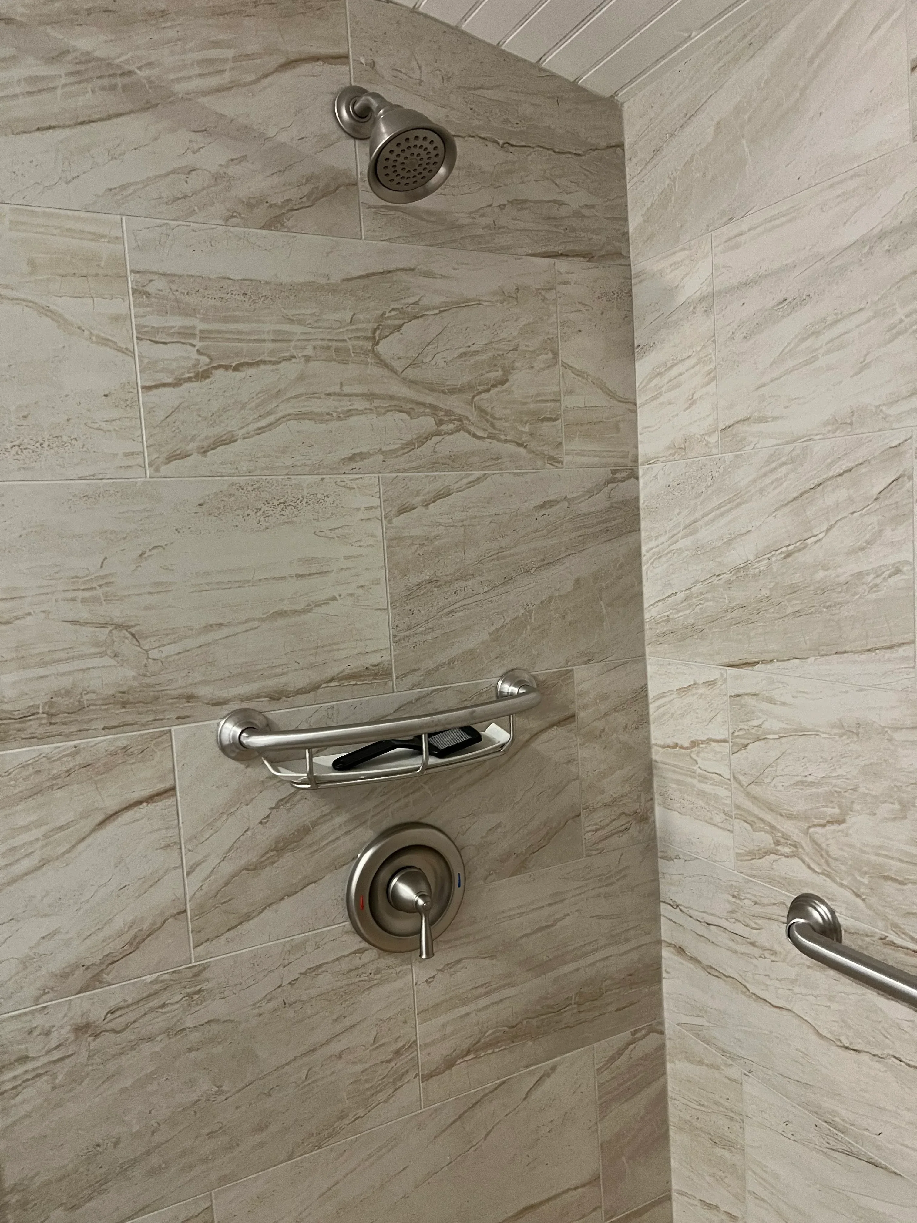 Marble-look porcelain tile shower with dual showerheads and chrome fixtures
