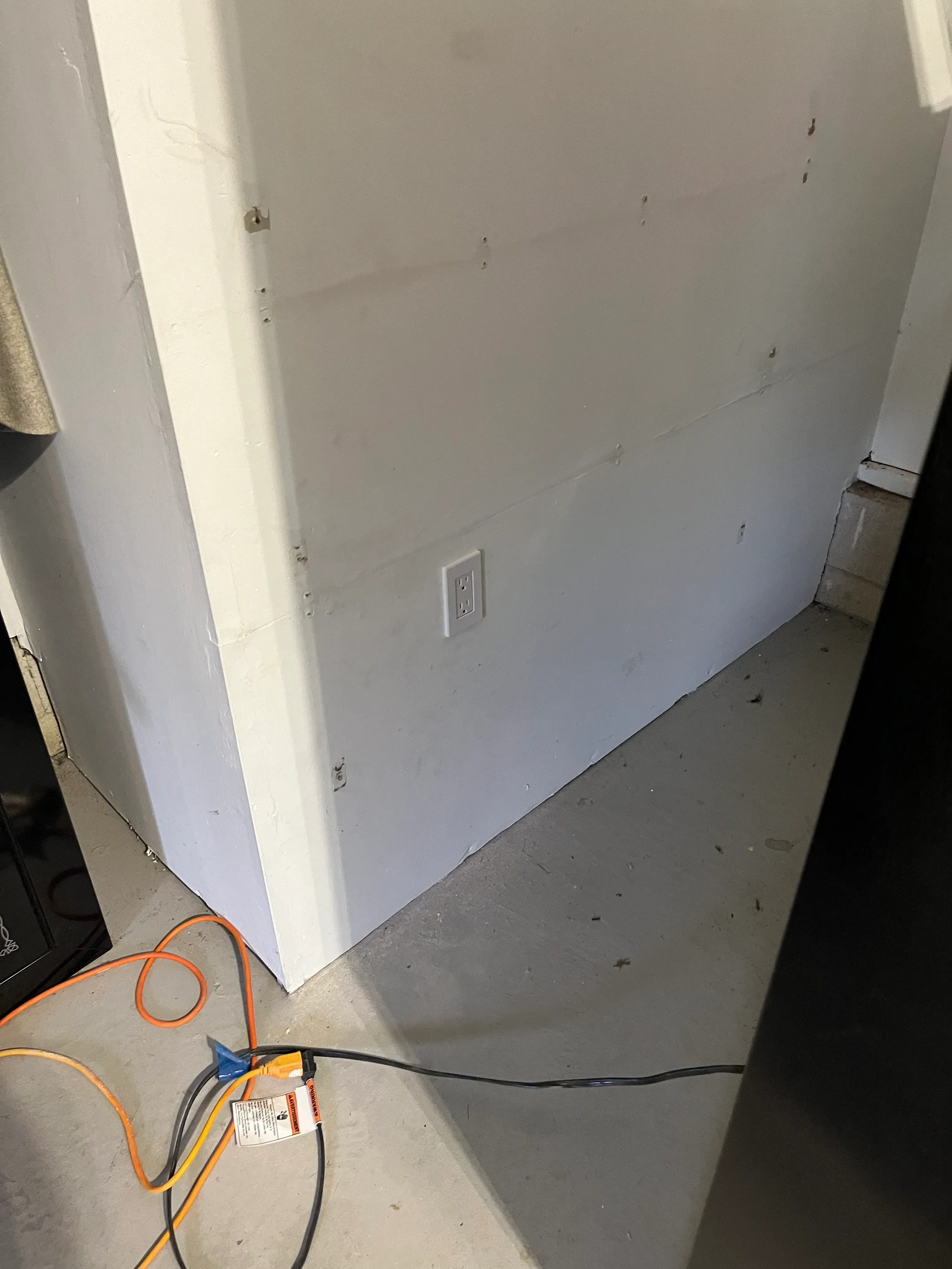 Drywall ceiling and walls with electrical outlet box and wiring during interior construction phase